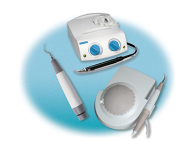 The image shows a dental care setup with various tools including an electric toothbrush, dental instruments, and a dental device on a blue background.